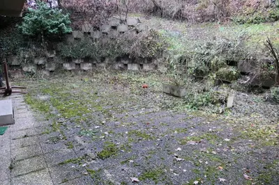 a garden with a stone wall and grass and plants at Les Chalet Du Soleil - Chalets du Soleil 9 MAE-6344 in Saint-Gervais-les-Bains