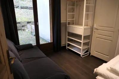 a room with a bed and an open closet at Les Chalet Du Soleil - Chalets du Soleil 9 MAE-6344 in Saint-Gervais-les-Bains