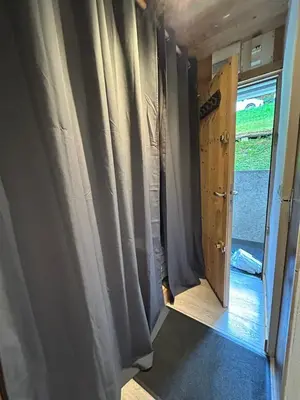 a door to a room with curtains and a window at Studio équipé / centre station in Les Carroz d'Araches