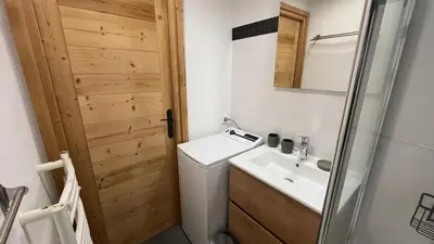 a bathroom with a toilet and a sink and a mirror at Cosy Criou - Appartement avec vue sur la montagne in Samoëns