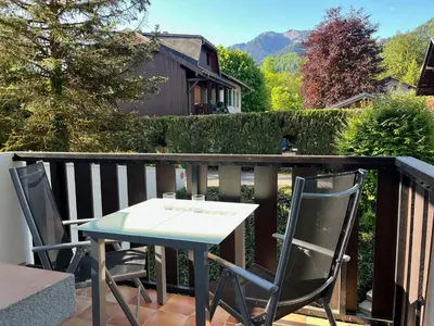 a table and two chairs on a balcony at Cosy Criou - Appartement avec vue sur la montagne in Samoëns