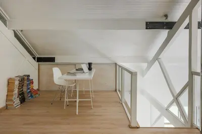 a room with a table and a chair in a attic at Chalet Hautbois - Family Chalet with 5 Bedrooms with Glacial views CHAMONIX - By Cozee Rentals in Chamonix-Mont-Blanc