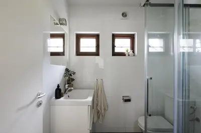 a white bathroom with a sink and a shower at Chalet Hautbois - Family Chalet with 5 Bedrooms with Glacial views CHAMONIX - By Cozee Rentals in Chamonix-Mont-Blanc