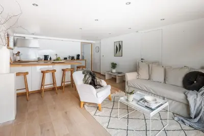 a dog sitting on a chair in a living room at Chalet Hautbois - Family Chalet with 5 Bedrooms with Glacial views CHAMONIX - By Cozee Rentals in Chamonix-Mont-Blanc