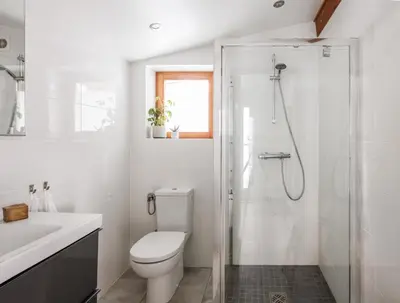 a white bathroom with a toilet and a shower at Chalet Hautbois - Family Chalet with 5 Bedrooms with Glacial views CHAMONIX - By Cozee Rentals in Chamonix-Mont-Blanc