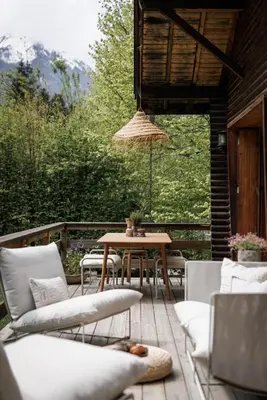 a patio with a table and chairs on a deck at Chalet Hautbois - Family Chalet with 5 Bedrooms with Glacial views CHAMONIX - By Cozee Rentals in Chamonix-Mont-Blanc
