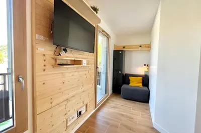 a tiny house with a flat screen tv on a wall at Refuge des Prés in Saint-Gervais-les-Bains
