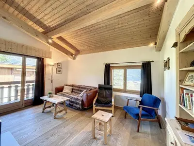 a living room with a couch and a table at Superbe 3 Pièces avec Balcons en Plein Cœur de Combloux - Parking, Wifi, Lave-linge - FR-1-560-106 in Combloux