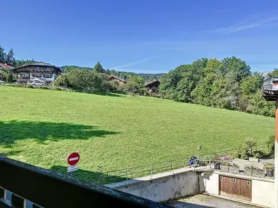 a large field of green grass with a stop sign at Superbe 3 Pièces avec Balcons en Plein Cœur de Combloux - Parking, Wifi, Lave-linge - FR-1-560-106 in Combloux