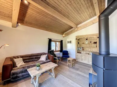 a living room with a couch and a stove at Superbe 3 Pièces avec Balcons en Plein Cœur de Combloux - Parking, Wifi, Lave-linge - FR-1-560-106 in Combloux