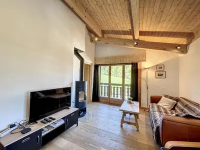 a living room with a couch and a flat screen tv at Superbe 3 Pièces avec Balcons en Plein Cœur de Combloux - Parking, Wifi, Lave-linge - FR-1-560-106 in Combloux
