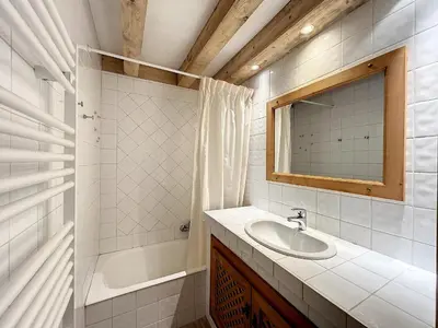 a bathroom with a sink and a tub and a mirror at Superbe 3 Pièces avec Balcons en Plein Cœur de Combloux - Parking, Wifi, Lave-linge - FR-1-560-106 in Combloux