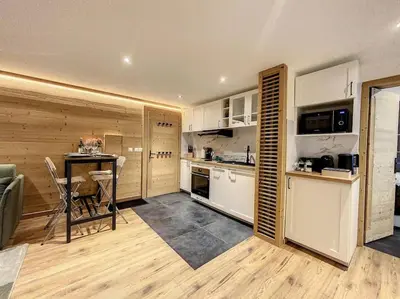 a kitchen with a table and a dining room at Évasion Parfaite in Chamonix-Mont-Blanc