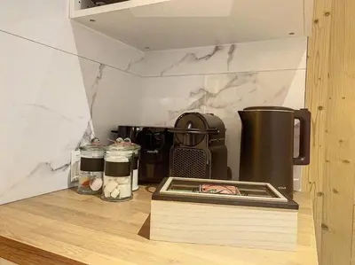 a kitchen counter with a coffee maker and a box at Évasion Parfaite in Chamonix-Mont-Blanc