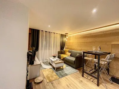 a living room with a couch and a table at Évasion Parfaite in Chamonix-Mont-Blanc