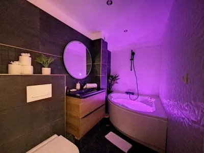 a purple bathroom with a sink and a bath tub at Évasion Parfaite in Chamonix-Mont-Blanc