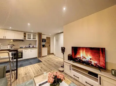 a living room with a large flat screen tv on a wall at Évasion Parfaite in Chamonix-Mont-Blanc