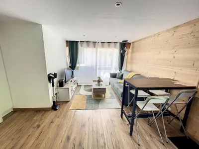 a living room with a table and a couch at Évasion Parfaite in Chamonix-Mont-Blanc