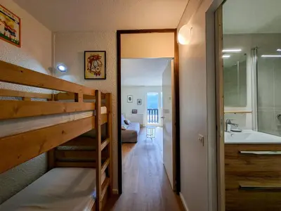 a small room with a bunk bed and a bathroom at Appartement Flaine Forêt in Flaine