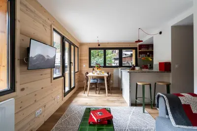 a kitchen and living room with a table in a tiny house at Chalet Nant Rouge in Les Contamines-Montjoie