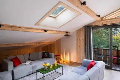 a living room with a couch and a table at Chalet Nant Rouge in Les Contamines-Montjoie