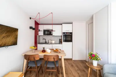 a small kitchen with a wooden table and chairs at Chalet Nant Rouge in Les Contamines-Montjoie