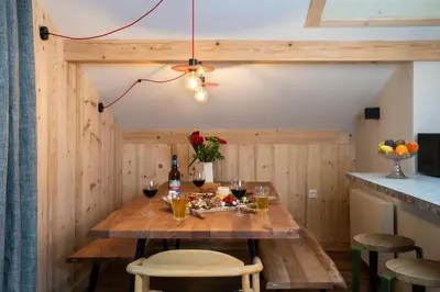 a dining room with a wooden table with wine glasses at Chalet Nant Rouge in Les Contamines-Montjoie