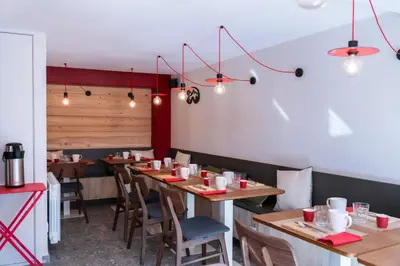 a dining room with wooden tables and chairs at Chalet Nant Rouge in Les Contamines-Montjoie
