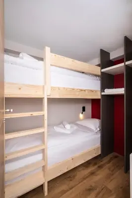 a room with two bunk beds and a bed at Chalet Nant Rouge in Les Contamines-Montjoie
