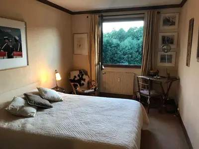 a bedroom with a large bed and a window at Charming Apartment ideal for families in Megève