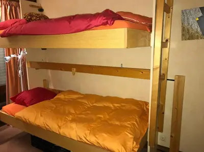 a couple of bunk beds in a room at Charming Apartment ideal for families in Megève