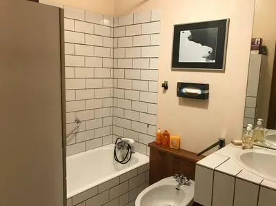 a bathroom with a sink and a toilet and a tub at Charming Apartment ideal for families in Megève