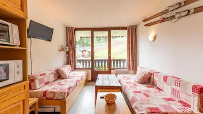 a living room with two couches and a tv at Grand Morillon 116 - Appt pied des pistes - 5 pers in Morillon