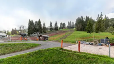 a dirt road in a field with a fence at Grand Morillon 116 - Appt pied des pistes - 5 pers in Morillon
