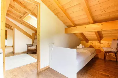 a bedroom with a bed in a room with wooden ceilings at L'Ecrin des Pècles - Centrale - Rénové - Immense Terrasse Face au Mont-Blanc in Chamonix-Mont-Blanc