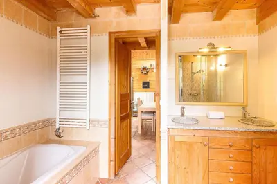 a bathroom with a tub and a sink at L'Ecrin des Pècles - Centrale - Rénové - Immense Terrasse Face au Mont-Blanc in Chamonix-Mont-Blanc
