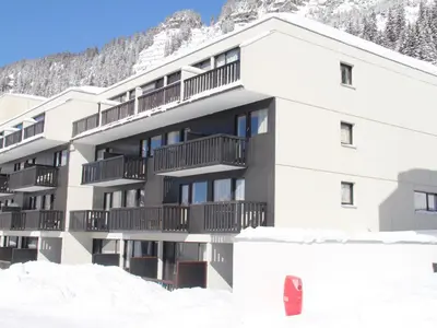 a living room with a blue couch and a table at Studio Confortable au Centre de Flaine avec Balcon - FR-1-425-200 in Arâches-la-Frasse