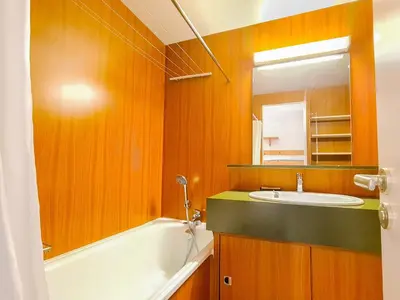 a kitchen with wooden cabinets and a white refrigerator at Studio Confortable au Centre de Flaine avec Balcon - FR-1-425-200 in Arâches-la-Frasse