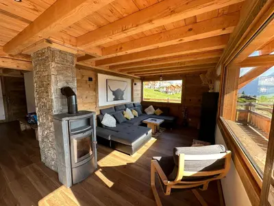 a living room with a couch and a fireplace at Chalet vue Mont Blanc avec jacuzzi extérieur in Combloux