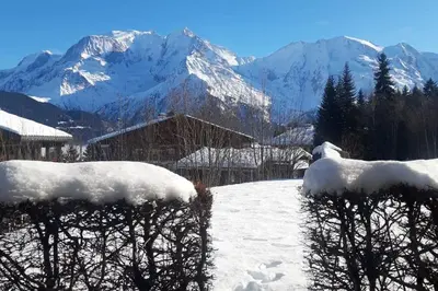 a snow covered mountain with mountains in the background at Mon refuge face au Mont Blanc in Saint-Gervais-les-Bains