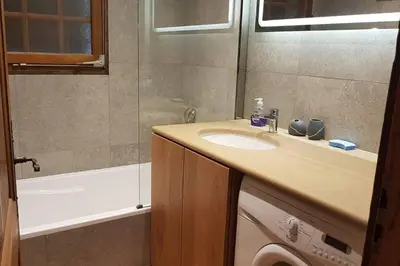 a bathroom with a sink and a bath tub at Mon refuge face au Mont Blanc in Saint-Gervais-les-Bains