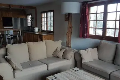 a living room with a couch and a table at Mon refuge face au Mont Blanc in Saint-Gervais-les-Bains