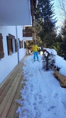 a person on skis walking down a snow covered sidewalk at Mon refuge face au Mont Blanc in Saint-Gervais-les-Bains