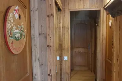 a hallway with wooden walls and a door in a room at Mon refuge face au Mont Blanc in Saint-Gervais-les-Bains