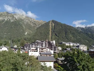 a group of buildings in front of a mountain at Studio élégant à Chamonix in Chamonix-Mont-Blanc