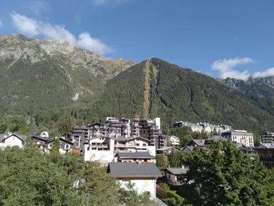 a group of houses in front of a mountain at Studio élégant à Chamonix in Chamonix-Mont-Blanc