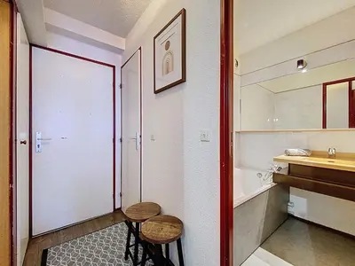 a small table on a balcony with a window at Coeur de Chamonix, Appartement, parking in Chamonix-Mont-Blanc