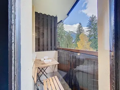 a living room with a couch and a table at Coeur de Chamonix, Appartement, parking in Chamonix-Mont-Blanc