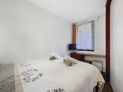 a bedroom with a bed with two pillows on it at Coeur de Chamonix, Appartement, parking in Chamonix-Mont-Blanc