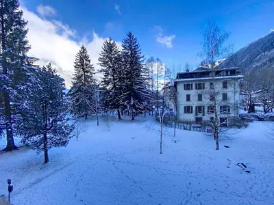 a house in the middle of a field with trees at Coeur de Chamonix, Appartement, parking in Chamonix-Mont-Blanc
